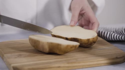 Time lapse. Step by step. Slicing russet potatoes in wedges with olive oil and spices to bake in the