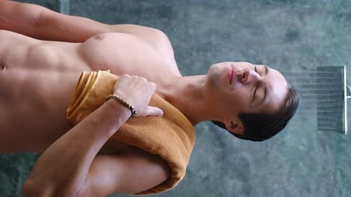 Muscular Man Showering in Modern Bathroom