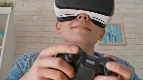Man Plays Video Game Using Virtual Reality Headset