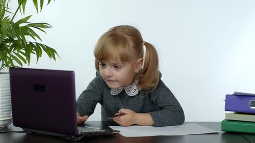 Young Girl Learning and Drawing at Desk
