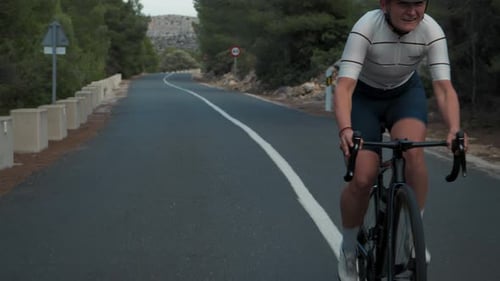 Young Pro Female Cyclist on Intense Road Training
