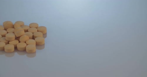 Orange Pills Piling in Studio Setting