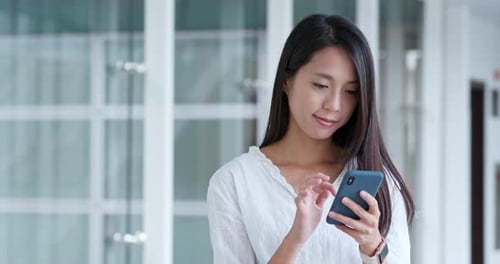 Woman use of cellphone in campus