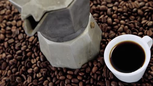 Coffeemaker with coffee beans and coffee mug