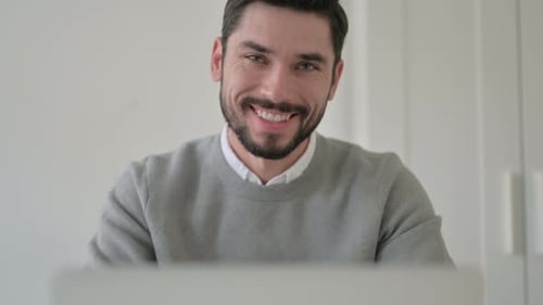 Close Up of Man Shaking Head As Yes Sign While Using Laptop