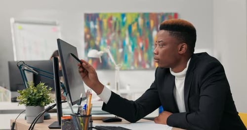 Handsome Darkskinned Man Corporate Office Worker Spends Morning in Front of Computer Points at