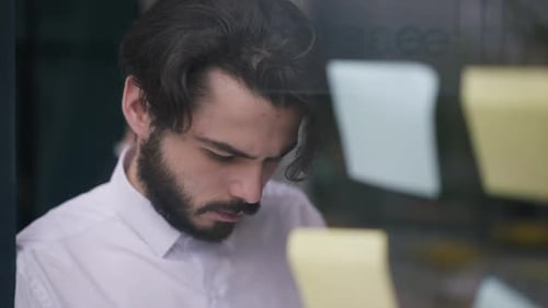 Focused Young Adult Brainstorming in Modern Office