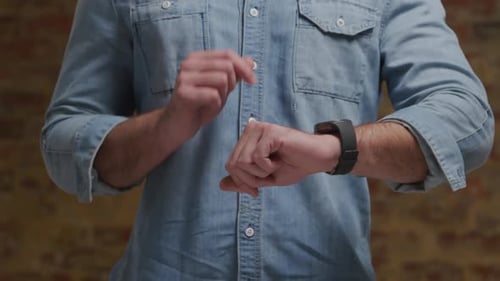 Man Interacting with Smartwatch Technology Close Up