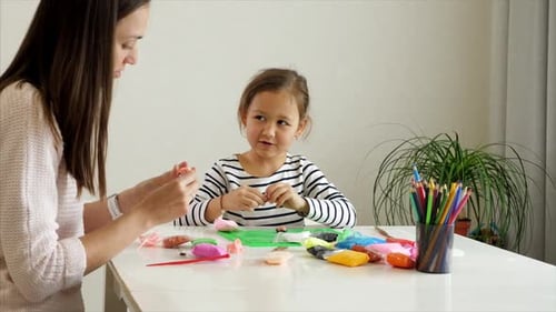 Woman and Girl Making Plasticine Crafts at Home