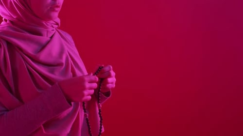 Woman in Headscarf Holding Prayer Beads