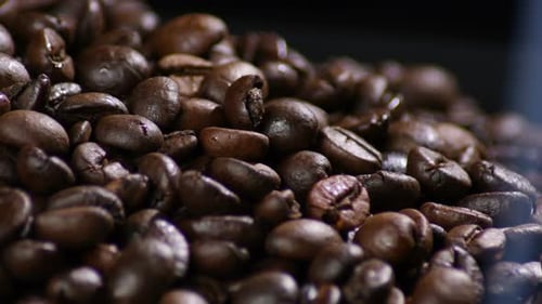 Roasted Coffee Beans Close Up with Smoky Aroma
