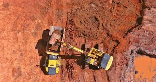 Excavator Scoop Loads a Soil in Dump Truck on Preparing Place to Construction Site for Residential