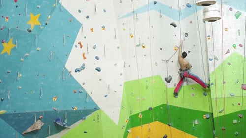 Man Climbing Indoor Rock Climbing Wall