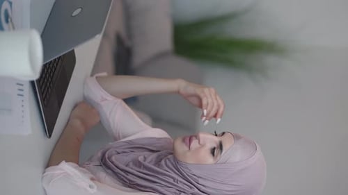 Woman Works on Laptop Computer at Home Desk