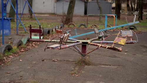 An Old Carousel Rotates in the Playground