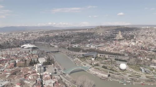 Aerial view of Tbilisi city central park and Bridge of Peace. Beautiful cityscape of old Tbilisi