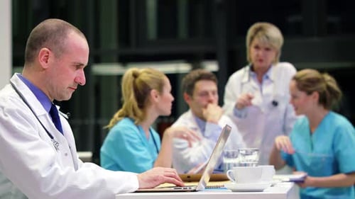 Medical Professionals Collaborating in Hospital Meeting