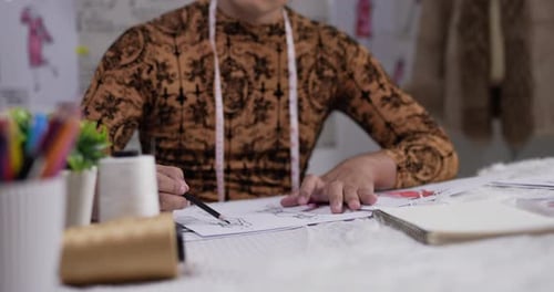 Close up hand of fashion designer man draws a sketch clothing