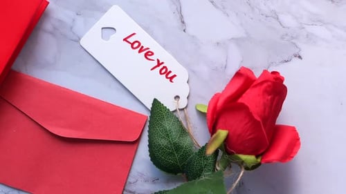 Top View of Gift Box, Envelope and Rose Flower on White Background