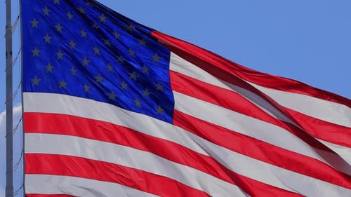 American Flag Waving in the Wind on Blue Sky