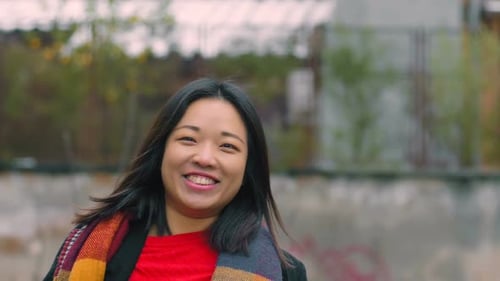 Smiling Woman Posing in an Urban Setting