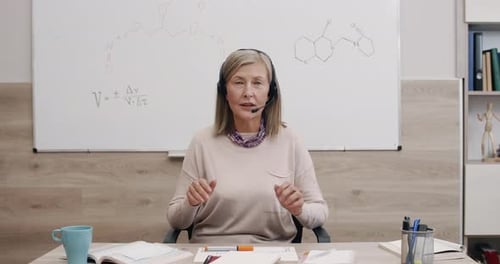 Woman Teacher Explains Science Lesson with Hand Gestures