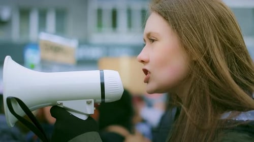 Woman Speaking into Megaphone at Outdoor Protest