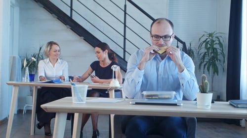 Employees Working at Desks in Modern Office