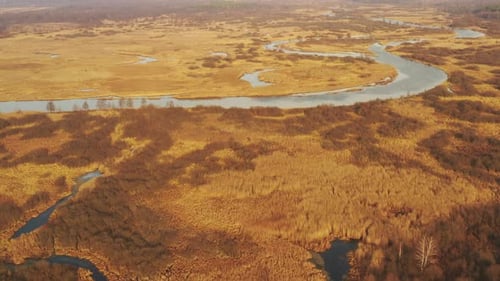 Aerial View Of Forest Woods And Partly Frozen River Landscape In Sunny Late Autunn Day