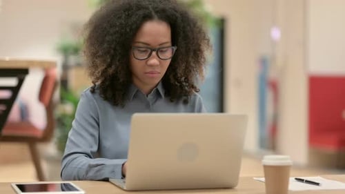 Woman Typing on Laptop at Desk