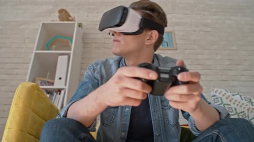 Young Man Playing VR Game at Home