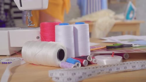 Sewing Machine and Sewing Supplies on the Table in the Studio of a Fashion Designer Close Up