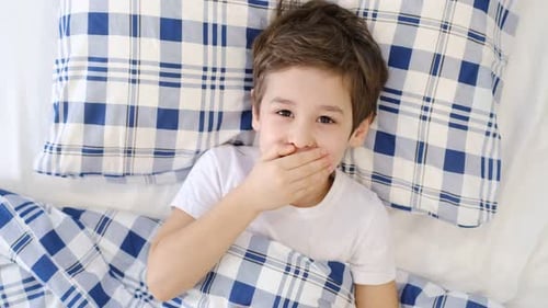 Sick Coughing Boy Kid Lying in Bed at Home