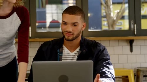 Man and Woman Discussing Project in Bright Cafe