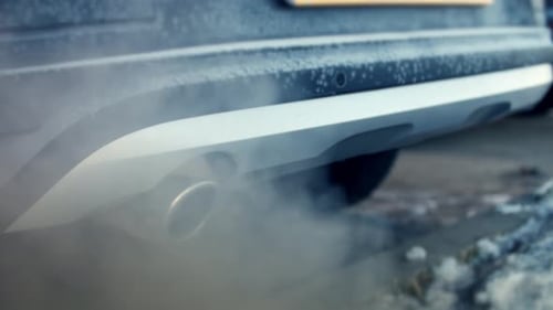 Smoke From Exhaust Pipe of a Frosted Car