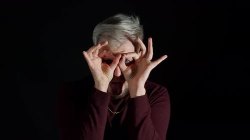 Man Making Funny Faces with Hands