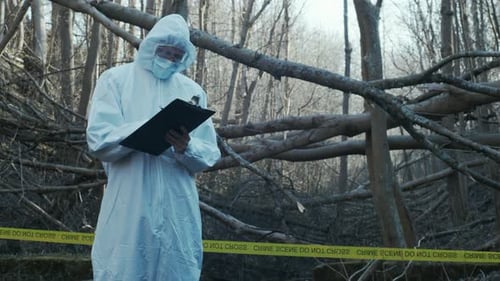 Forensic specialists working in the forest. Crime scene and police concept.