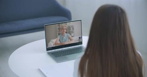 High Angle View of Video Conference with Teacher on Laptop at Home. Girl in Video Call with Personal