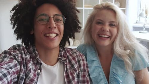 Cheerful Couple Smiling and Waving at Camera