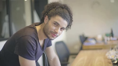 Young man writing notes in office