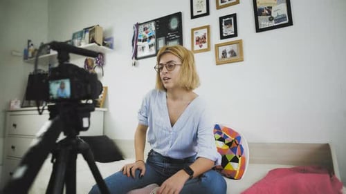 Woman Vlogging in Bright, White Bedroom