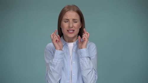 Woman Crossing Fingers and Wishing for Good Luck