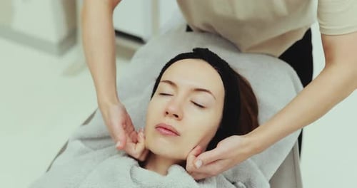 Woman Receives Facial Massage at Beauty Clinic