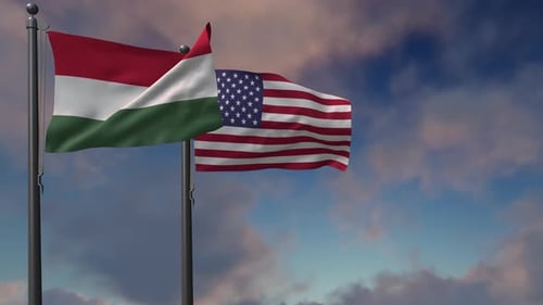 Hungary and USA Flags Waving against Blue Cloudy Sky