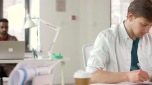 Ui Designers with Templates and Laptop at Office 21