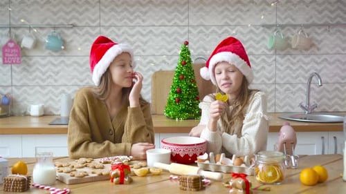 Happy Girls Baking Christmas Cookies at Home
