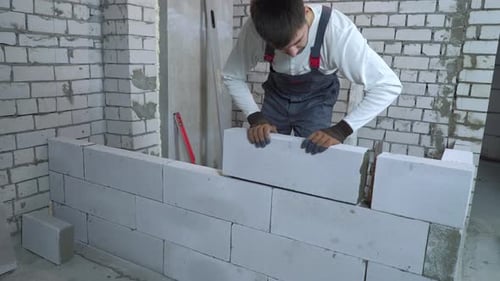Builder in Uniform Laying Aerated Concrete Blocks