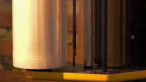 Closeup Automatic Machine Wrapping Wooden Box in a Stretch Tape