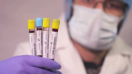 Medical Worker Holding Coronavirus Test Tubes
