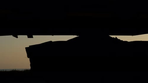 Silhouetted Vehicles Driving at Sunrise